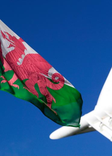 Welsh flag against a blue sky.