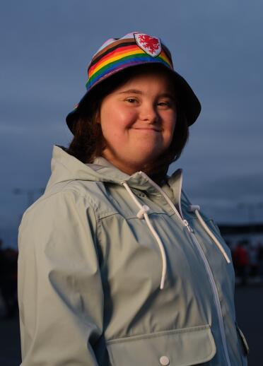 A person smiling at the camera wearing a bucket hat.