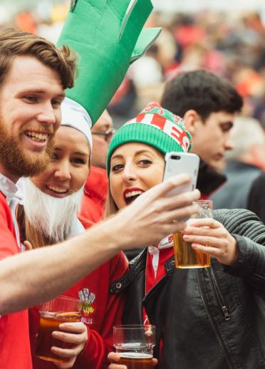 Image of Welsh rugby fans taking a selfie together.