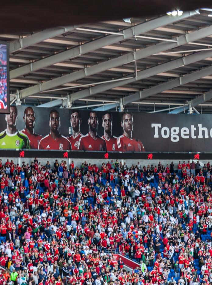 Multitud de personas en un partido de fútbol de Gales.