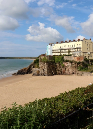 Houses on a cliff looking over the beach and sea.