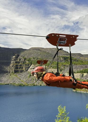 Person riding a Zip Wire over Penrhyn Slate Quarry