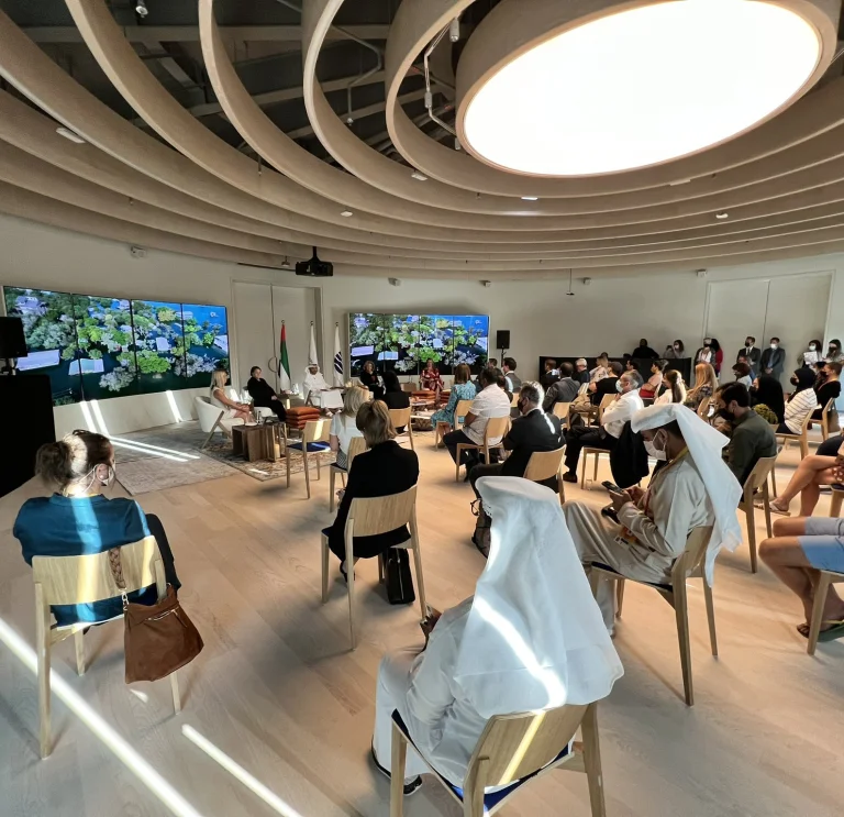 Sophie Howe speaking on a panel to a seated audience at Expo's Sustainability for All World Majlis during Climate & Biodiversity Week at the UK Pavilion