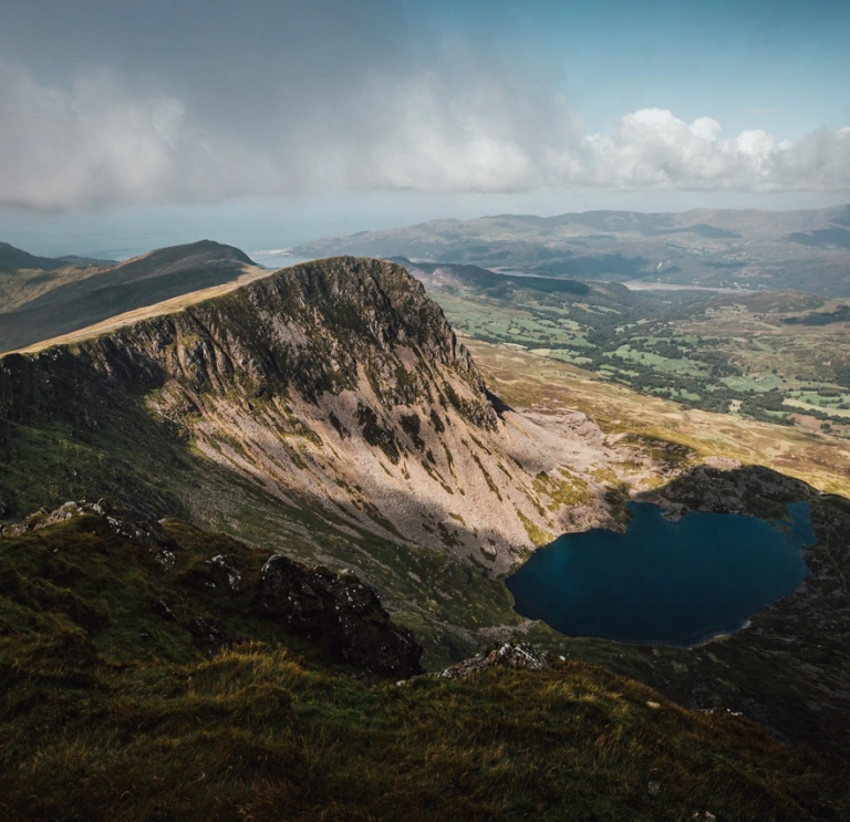 Aerial image of a large mountain with a lake at its base