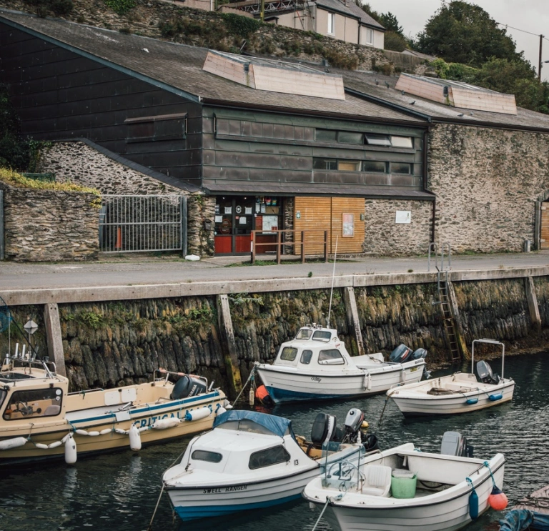 Boats moored alongside a picturesque quay area