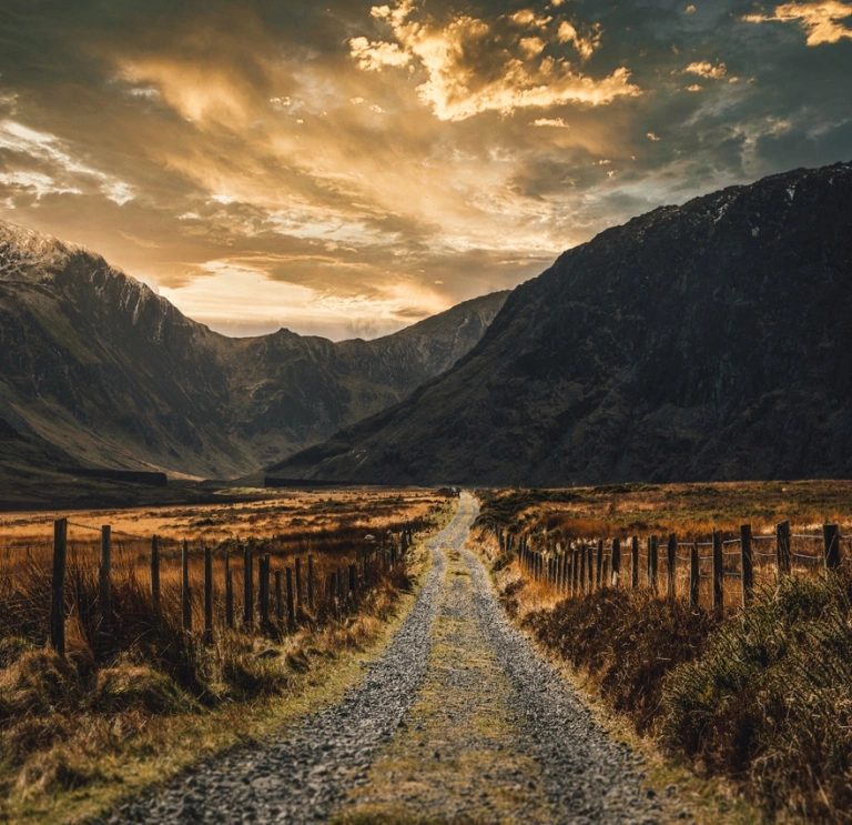 A long slate track leading into the middle of beautiful mountains