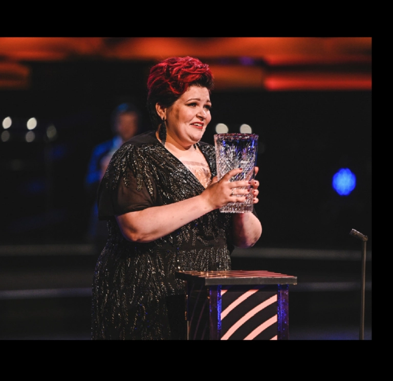 singer holding trophy.