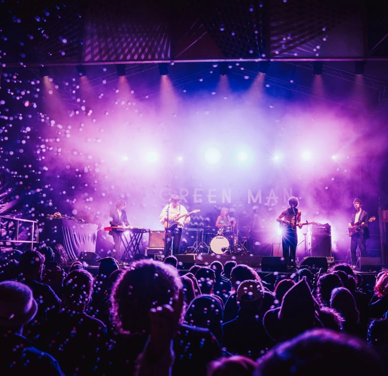 A band on stage playing music.