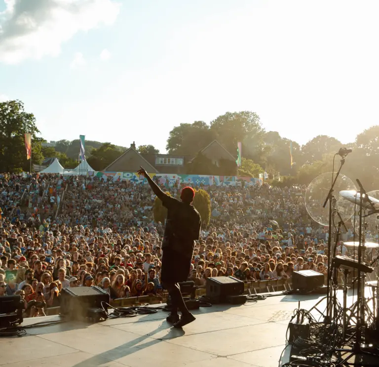 Man on stage in front of hundreds performing