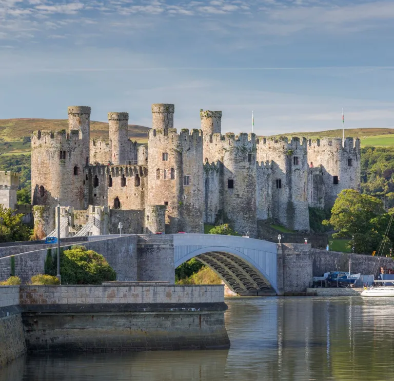 A view of the castle surrounded by a water.