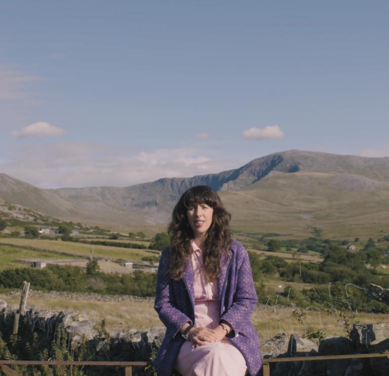 Lisa Jen sentada en un muro en Snowdonia.