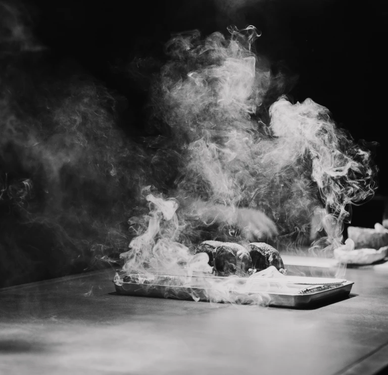 A steaming steak on a board.