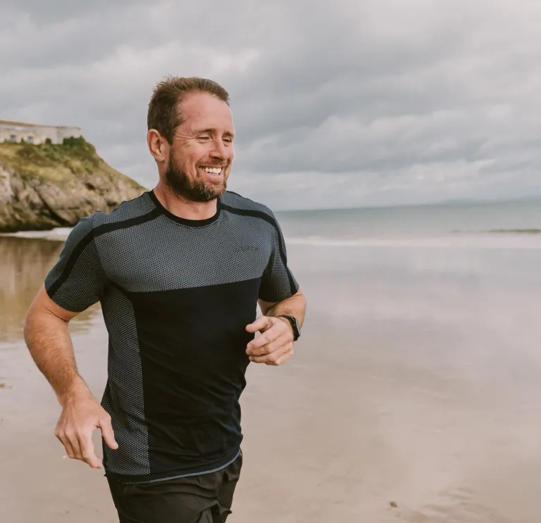 Shane Williams running along the beach.