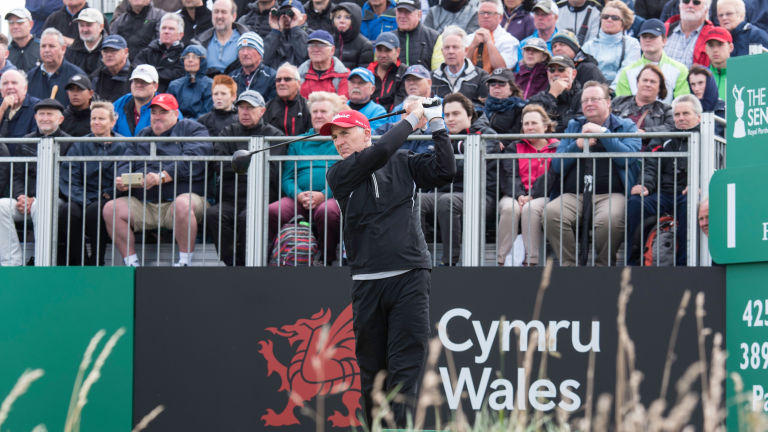 Phil Price playing golf at the Senior Open 2017 Royal Porthcawl Golf Club and crowd watching.