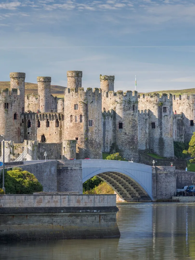 A view of the castle surrounded by a water.