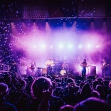 A band on stage playing music.