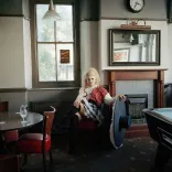 Drag queen Catrin Feelings sitting in a Welsh pub